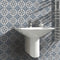 Lifestyle image of the Vintage Floral tile being used behind a sink in the bathroom to create a blue, white and light brown floral design feature wall