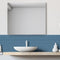 House of Mosaics Mini Metro Lapis Blue self-adhesive mosaic tile sheet, being used as a splashback behind a sink in a bathroom