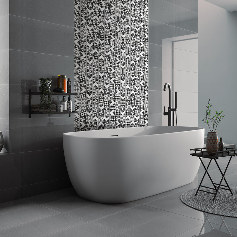 Monomix self-adhesive mosaic being used as a vertical border in a bathroom between large format grey tiles