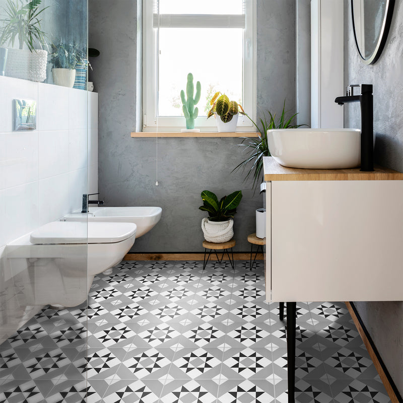 Lifestyle image showing a bathroom with a sink and cabinet, with the Diamond Tile on the floor showing the white, grey and black overall finished design
