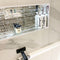 Cannes Silver mosaic tile being used within a zoned area of a bathroom wall which holds bathroom accessories such as a candle
