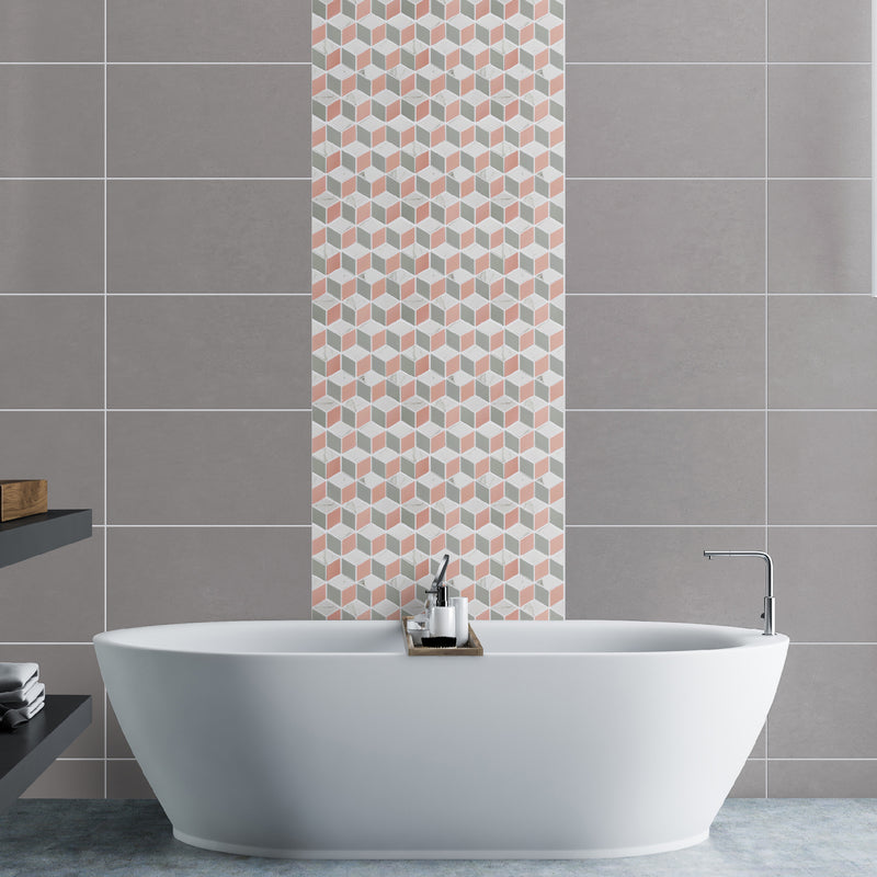 Hexia Blush mosaic tile lifestyle image showing the mosaics being used in a zoned wall area in the bathroom behind the bath, with larger grey format tiles on the wall
