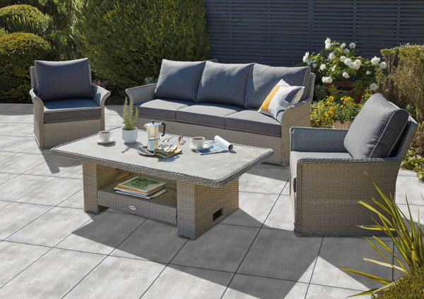 Outdoor Porcelain Tile AK Rose showing the grey concrete style tile being used outdoors. With a grey / brown sofa set.