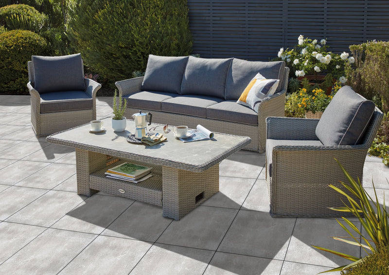 Outdoor Porcelain Tile AK Rose showing the grey concrete style tile being used outdoors. With a grey / brown sofa set.