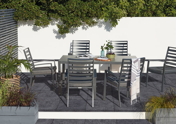 Outdoor Porcelain Tile Bluestone Dark Grey being used in a garden patio, with a dark grey seating area.