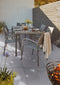 Outdoor Porcelain Tile Calacatta Nexa, showing the white marble effect pattern with grey veining being used outdoors, with a table and chair set