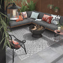 Lifestyle image showing the House of Mosaics Outdoor Porcelain Nordic Decor tile, being used in an outdoor living space as a 'rug', with the grey Nordic tiles