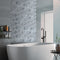 Lifestyle image of Stone Etch Mosaic, showing the grey marble mosaic as a zoning area in a bathroom