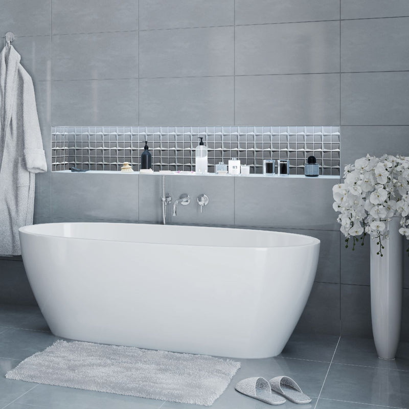 The Stargazer Grey Mosaic being used as a zoning area in a bathroom. This zoned area is cut back into the wall to create a shelf above the bath.